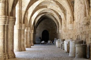 A stone archway with stone pillars at the Hospital of the Knights in Rhodes, Greece.