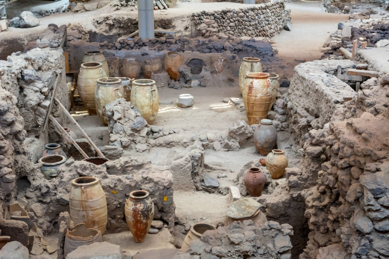 A room full of jars and pots from the prehistoric town Akrotiri in Santorini, Greece, in a museum.