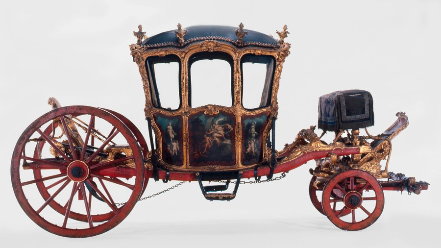 Ornate vintage carriage with decorative gold accents and painted panels, perfect for things to do in Europe over Easter.