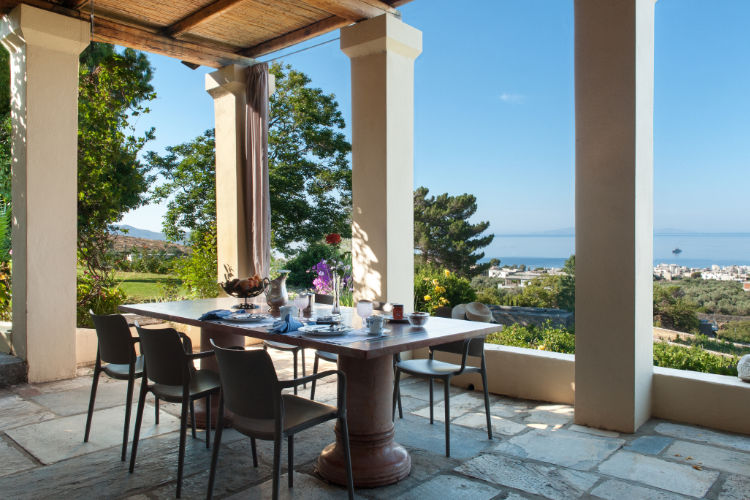 An outdoor dining area with a view of the sea.