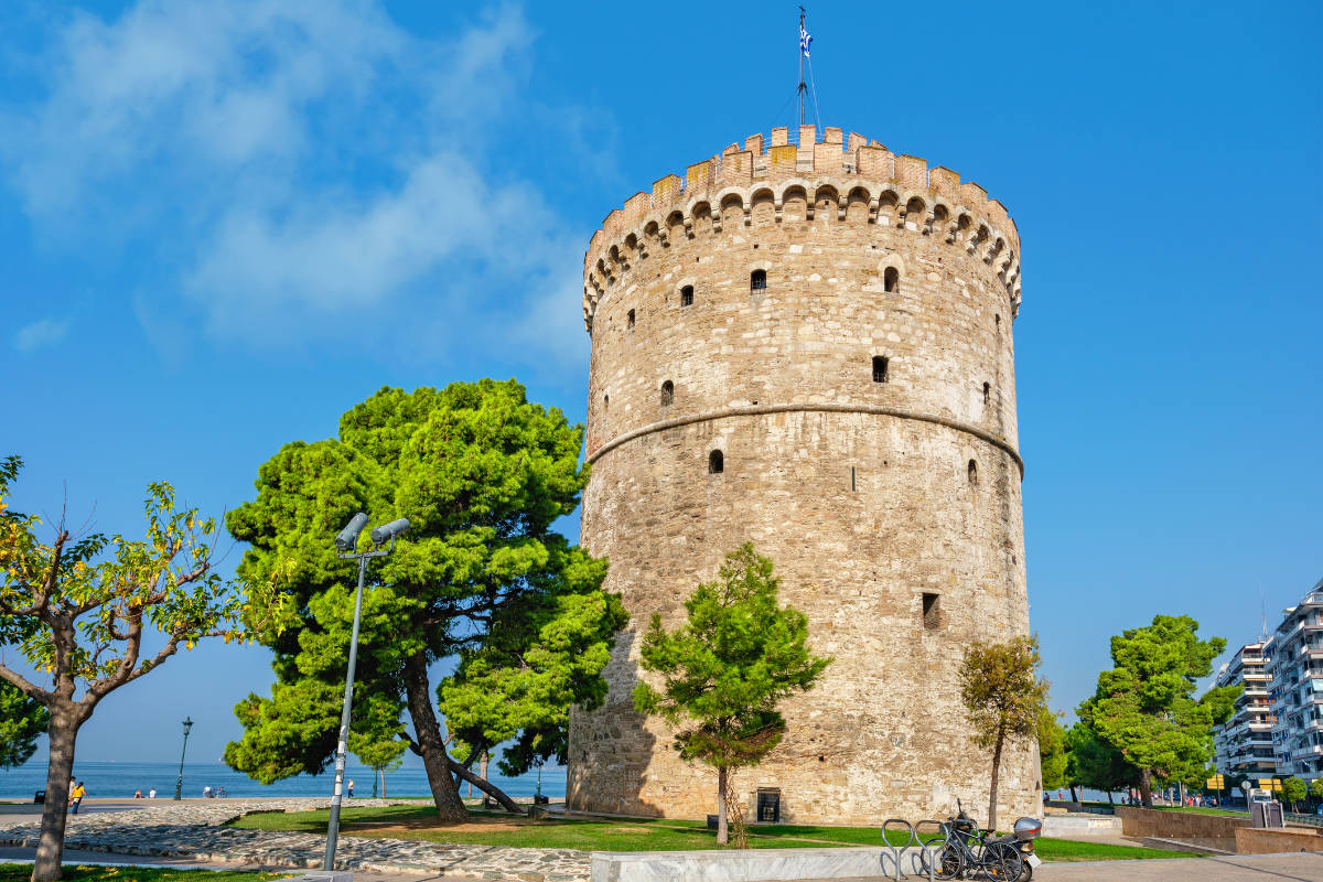 The white tower of thessaloniki, greece, on a clear day with blue skies.