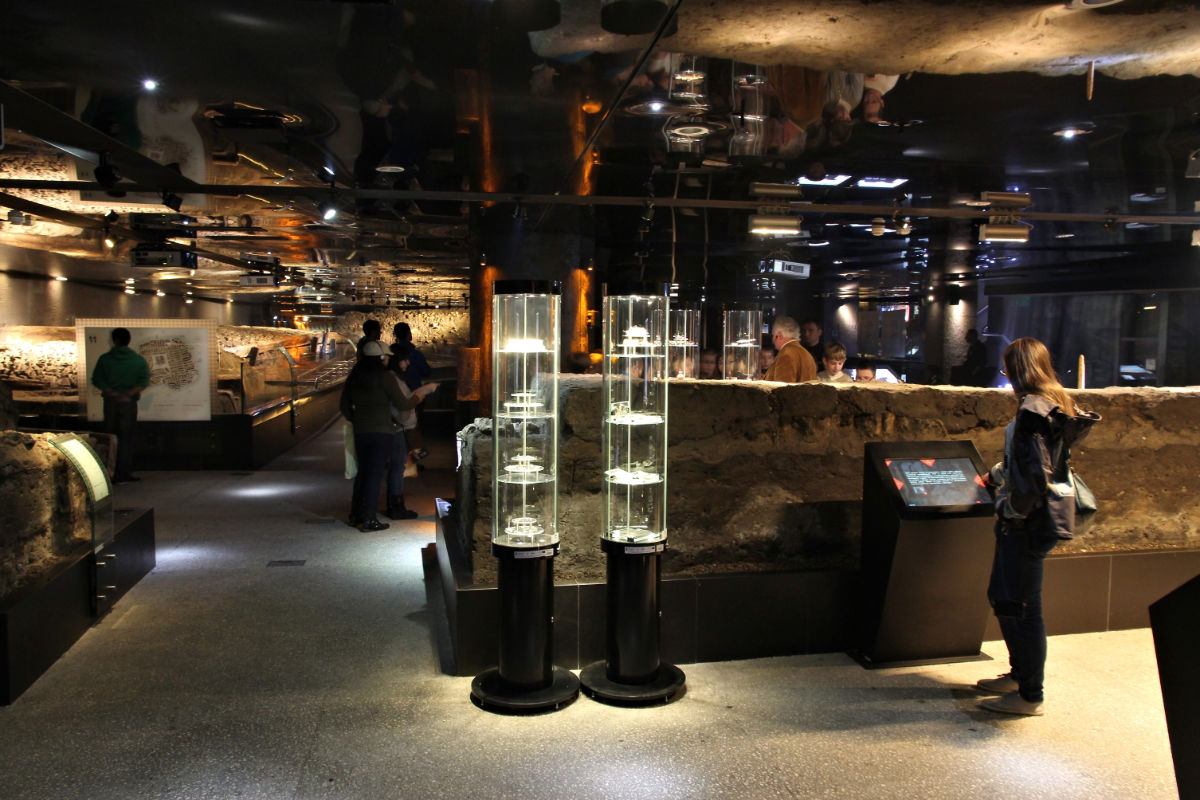 Visitors exploring an exhibit at Rynek Underground Museum in Krakow, Poland.