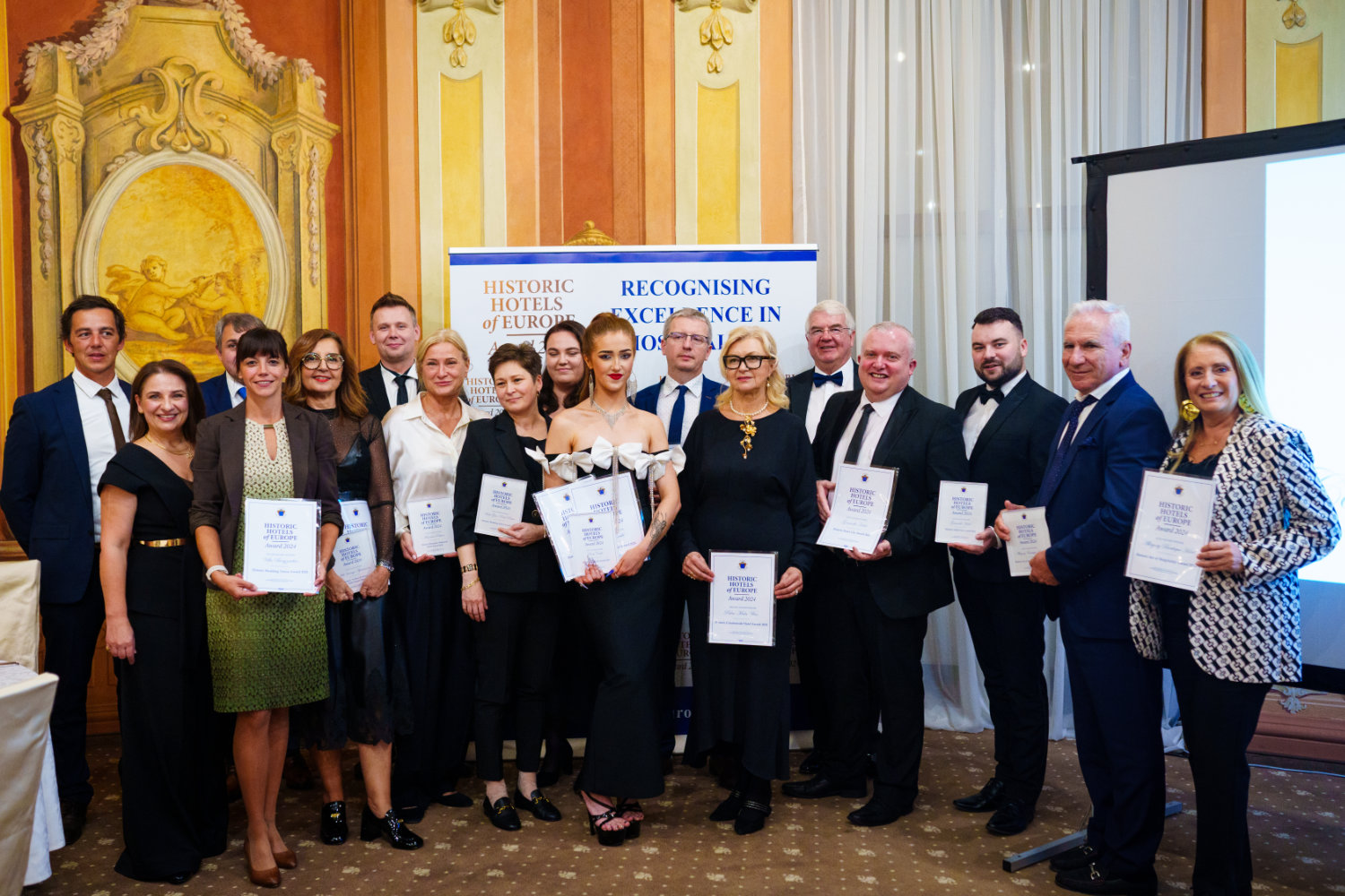 The Award winners holding certificates at the prestigious Historic Hotels of Europe Awards 2024, at Chateau Liblice in Czech Republic.