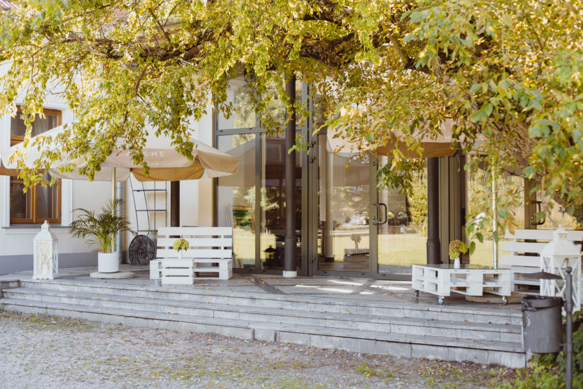 L'area esterna del Pałac i Folwark Łochów è caratterizzata da panchine e tavoli in legno, situati sotto i grandi alberi di fronte all'edificio storico. Lanterne bianche e piante in vaso aggiungono tocchi affascinanti a questo spazio sereno.