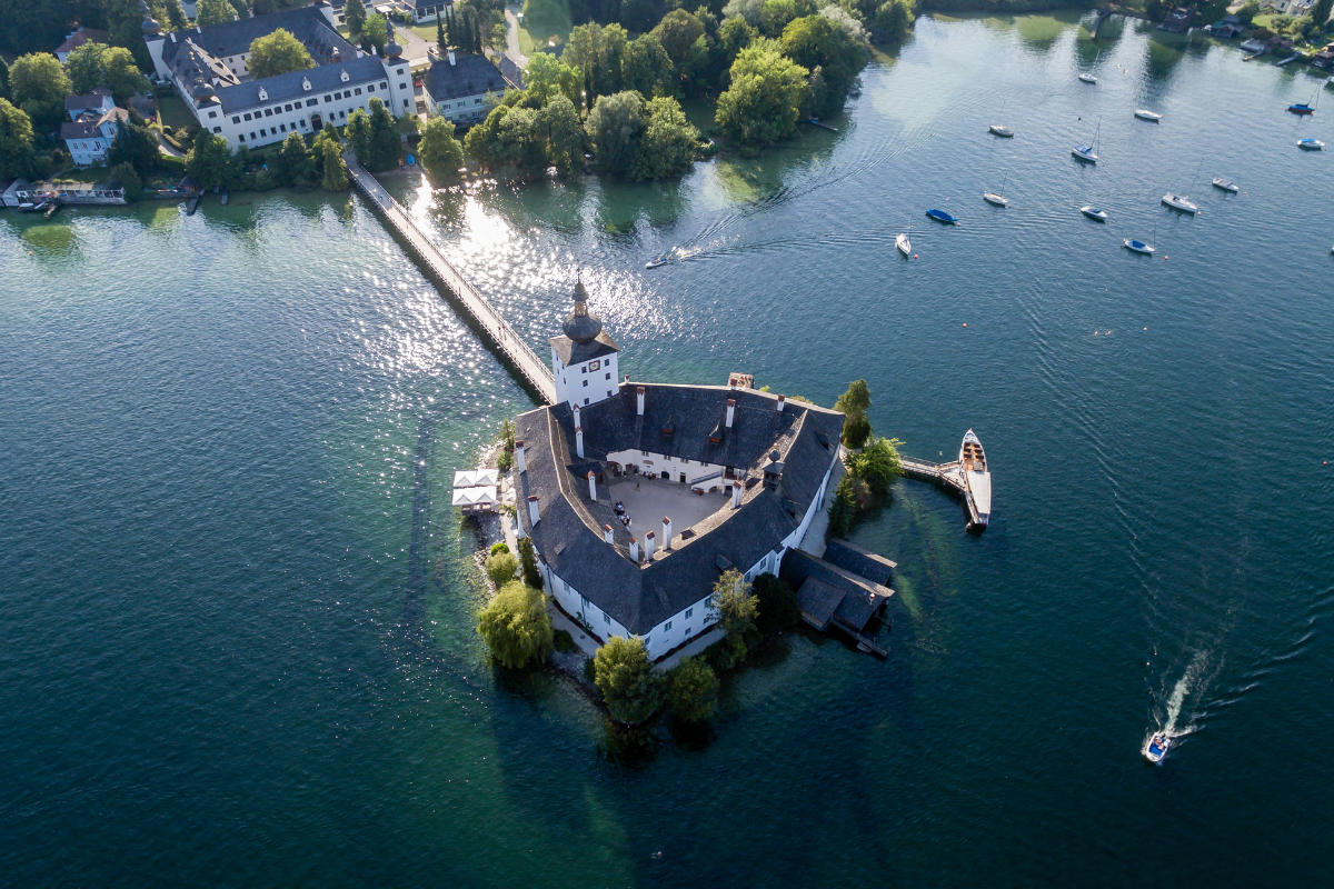 Aerial view of the historic castle Ort on a small island in lake traun in Austria.